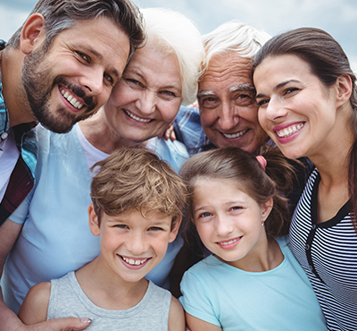 Happy multi-generation family standing outdoors
