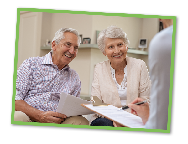 Senior couple reviewing estate plan with their attorney.